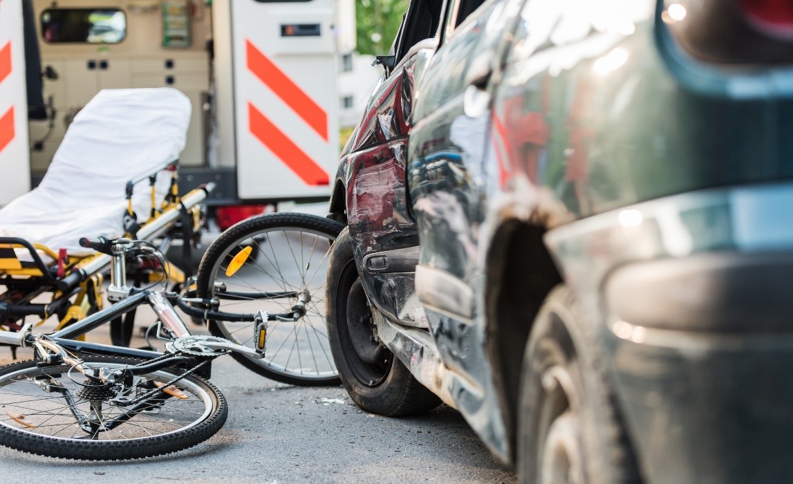 A bicycle parked next to a car

Description automatically generated